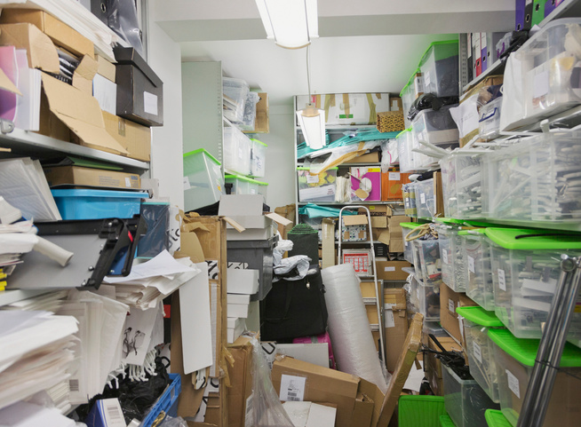 Messy office storage closet.